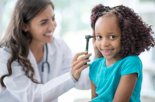 doctor checking child's ear