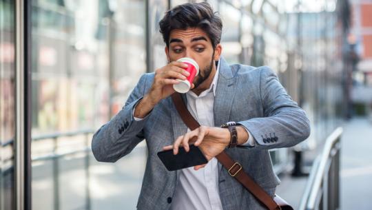man rushing, drinking coffee, checking watch