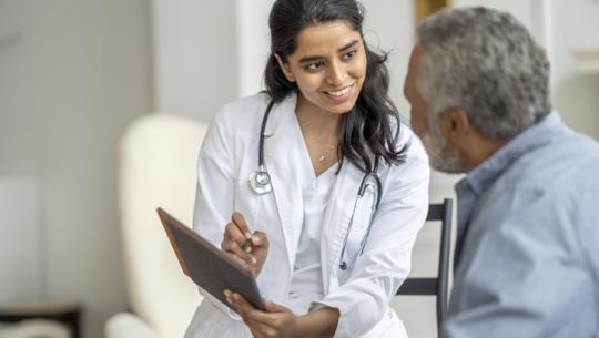 female doctor talking to male patient 