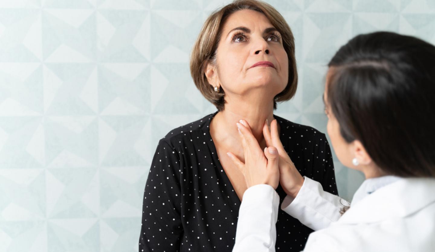 dr. checking thyroid
