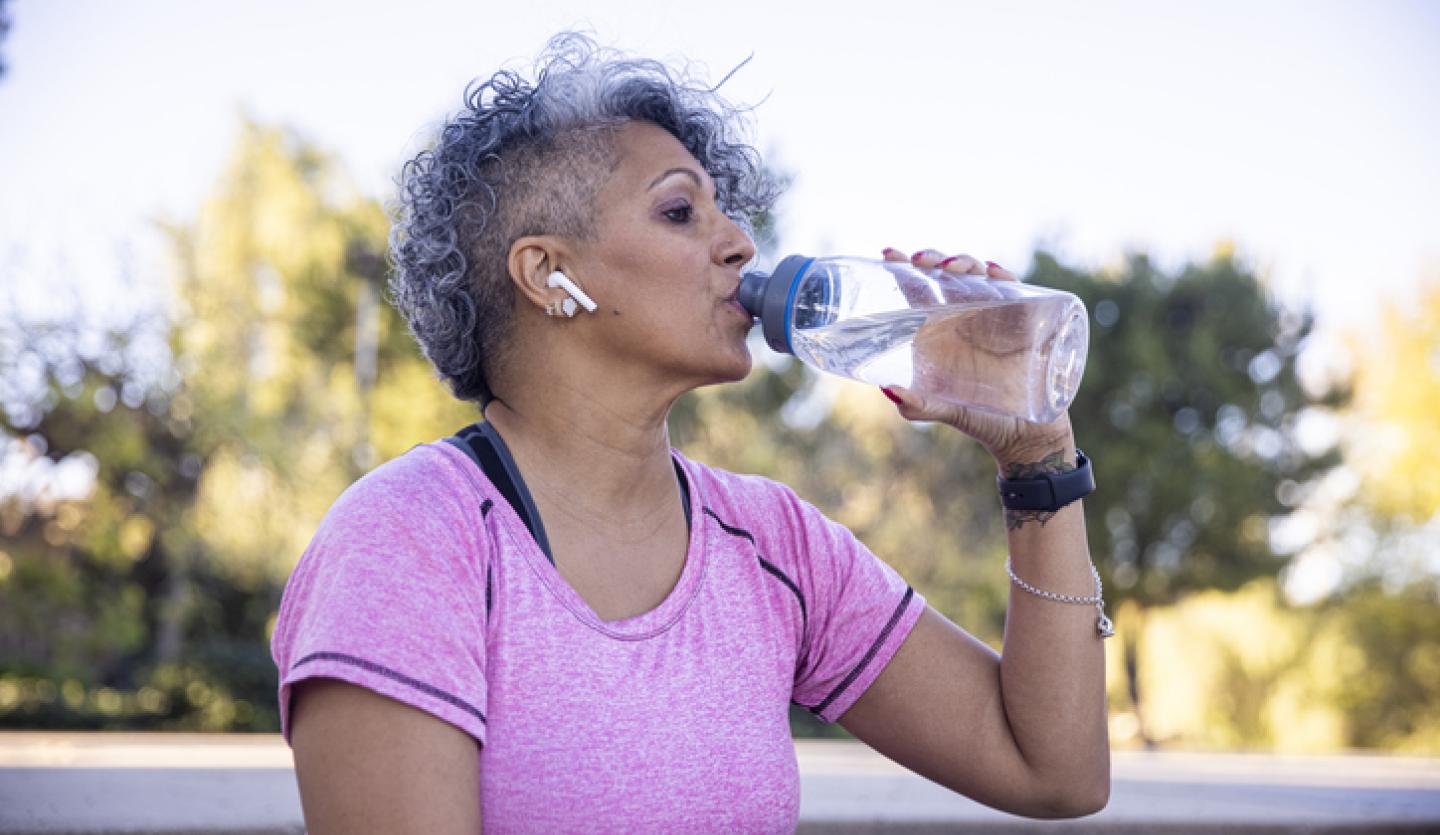 woman drinking water outside