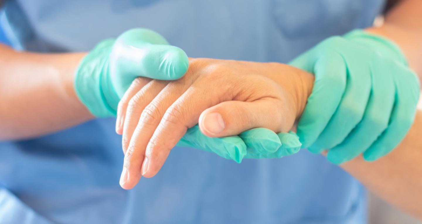 medical professional holding a person's hand