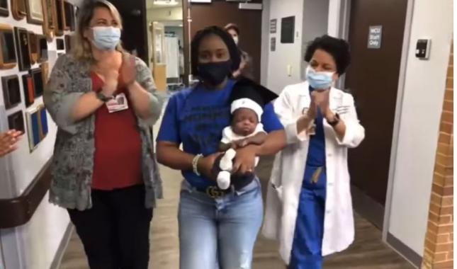 baby zion with mom and staff