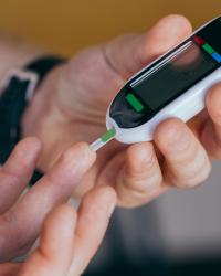 Person using finger stick to monitor diabetes