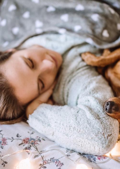woman and dog sleeping
