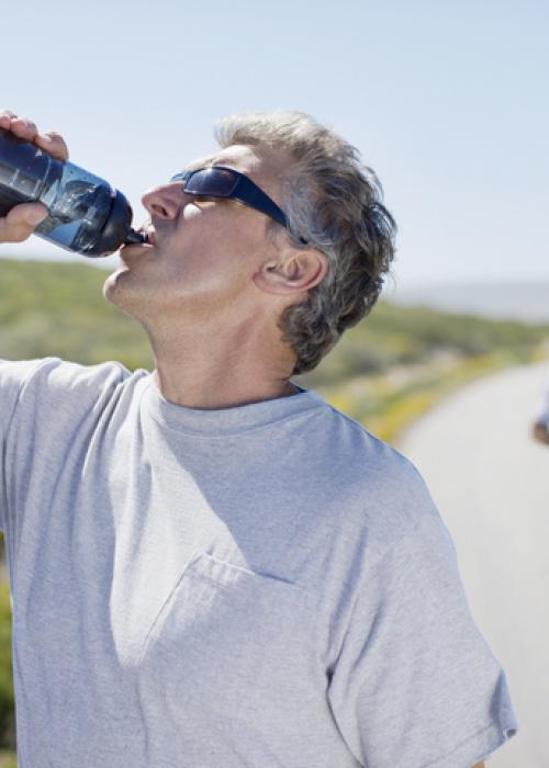 man drinking from water bottle