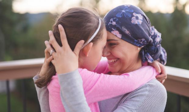 mother with cancer hugging daughter