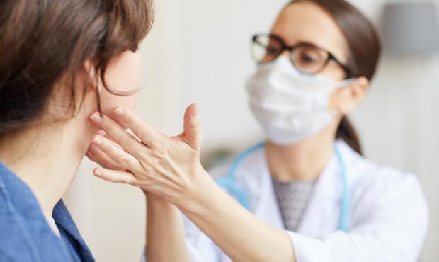 doctor checking patient's throat